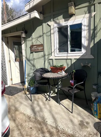 a backyard of a house with table and chairs