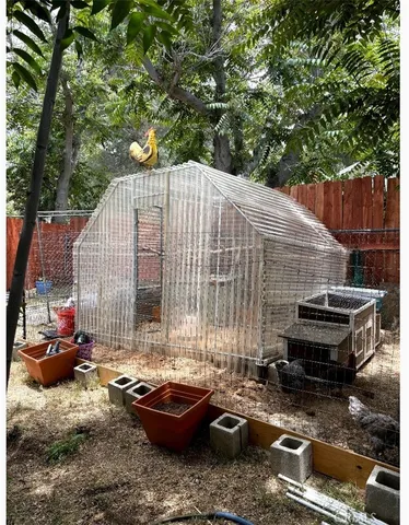 a backyard of a house with barbeque oven and outdoor seating