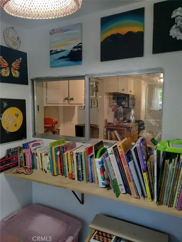 a backyard of a house with large trees and wooden fence
