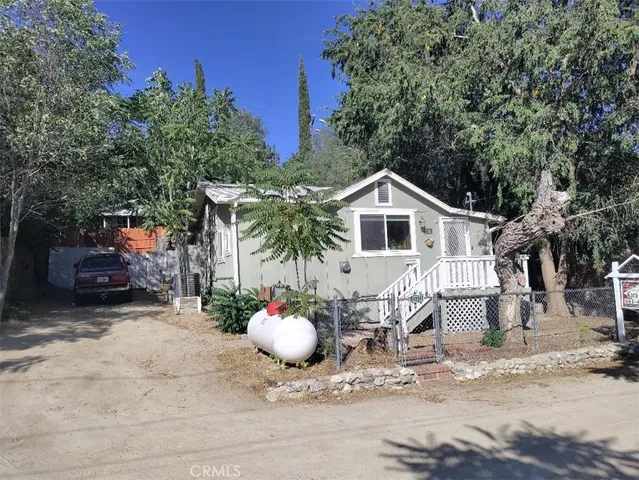 a view of a yard with wooden fence