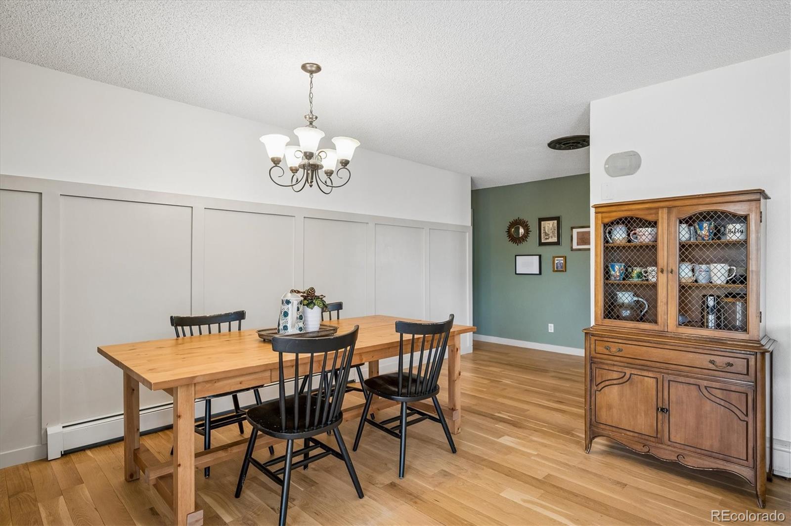 4654 South Union Street Morrison, CO 80465 - Photo 11 of 34 a view of a dining room with furniture window and wooden floor