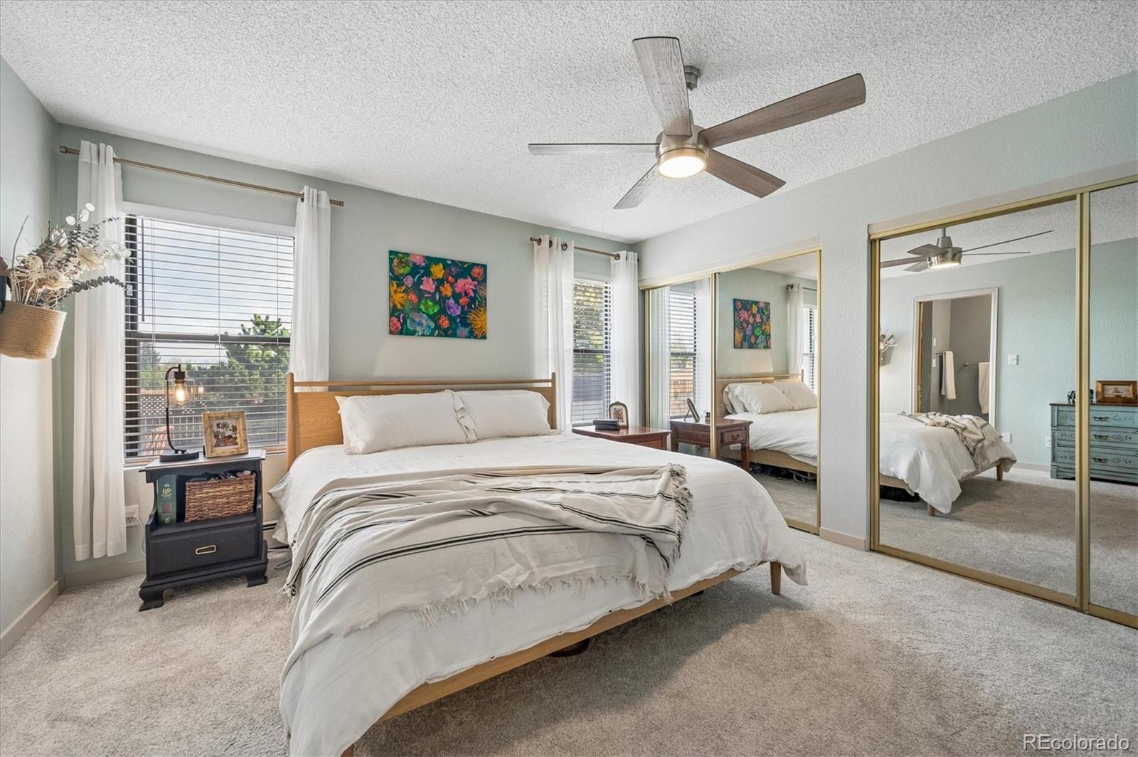 4654 South Union Street Morrison, CO 80465 - Photo 13 of 34 a spacious bedroom with a bed and a chandelier