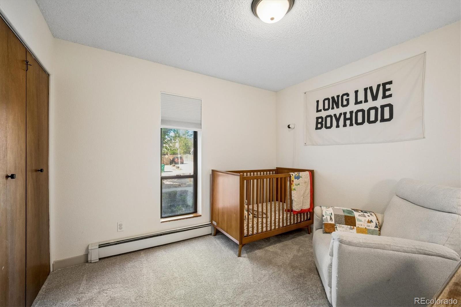 4654 South Union Street Morrison, CO 80465 - Photo 19 of 34 a bedroom with a bed and a window