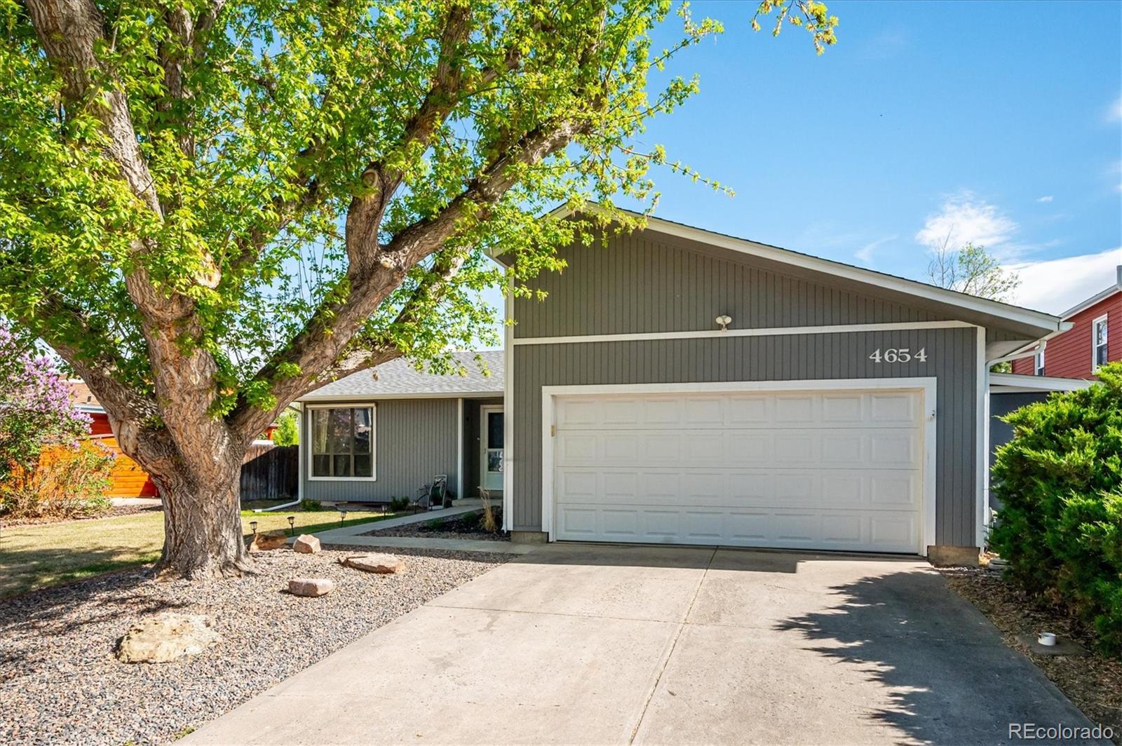 4654 South Union Street Morrison, CO 80465 - Photo 2 of 34 a front view of a house with a yard and garage