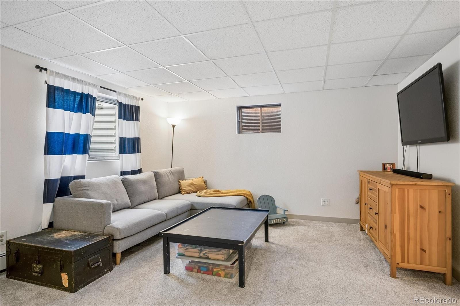 4654 South Union Street Morrison, CO 80465 - Photo 22 of 34 a living room with furniture and a flat screen tv