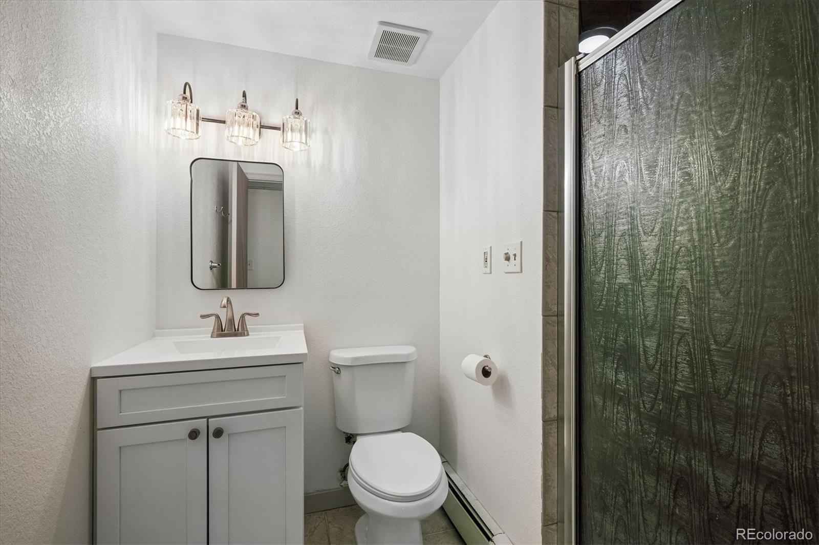 4654 South Union Street Morrison, CO 80465 - Photo 26 of 34 a bathroom with a sink a toilet and shower