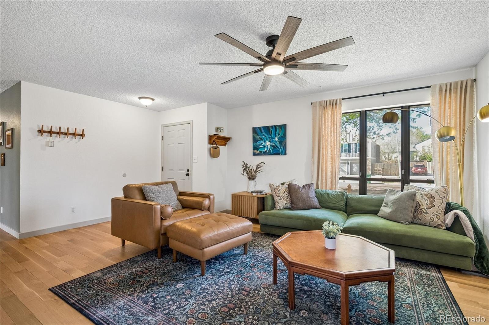 4654 South Union Street Morrison, CO 80465 - Photo 3 of 34 a living room with furniture and a rug