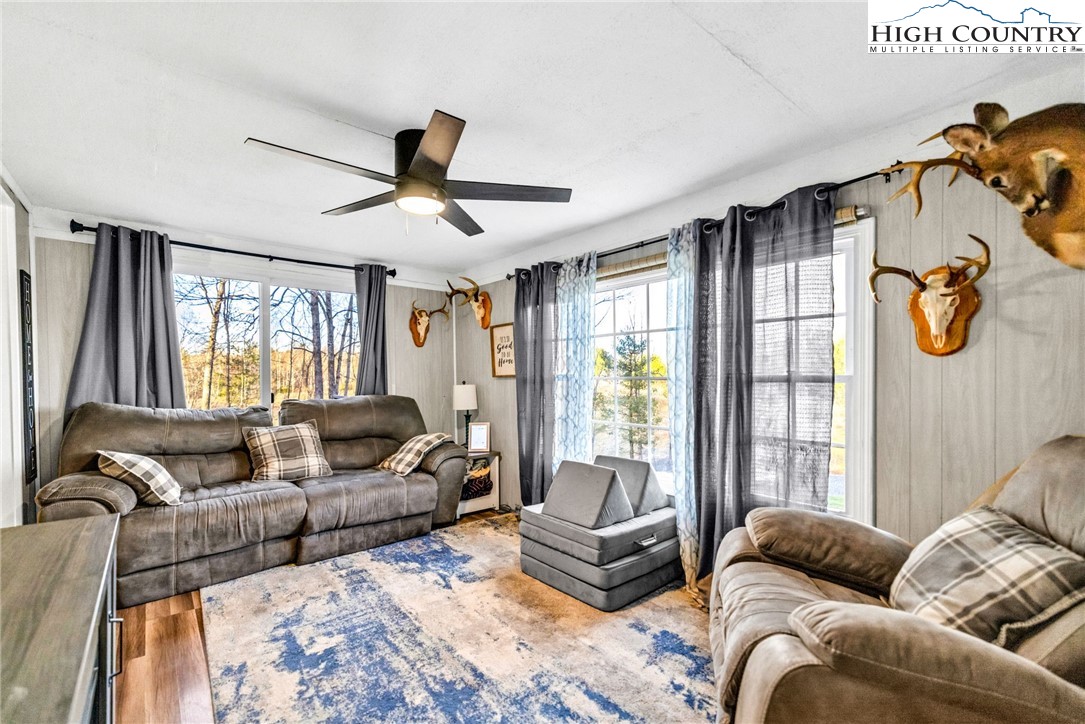 747 Nathans Creek School Road Crumpler, NC 28617 - Photo 6 of 42 a living room with furniture ceiling fan and a window