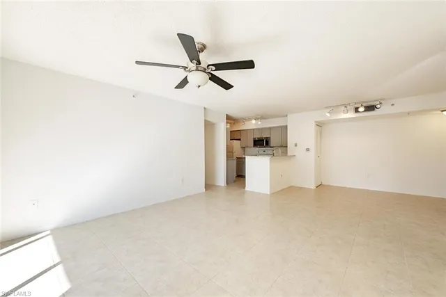 a view of a kitchen with a sink and refrigerator