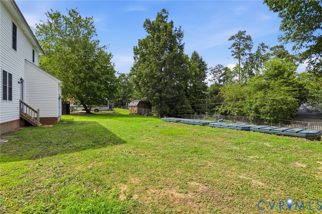 14420 Branding Iron Road Chesterfield, VA 23838 - Photo 36 of 50 Expansive green lawn with a white vinyl-sided exte