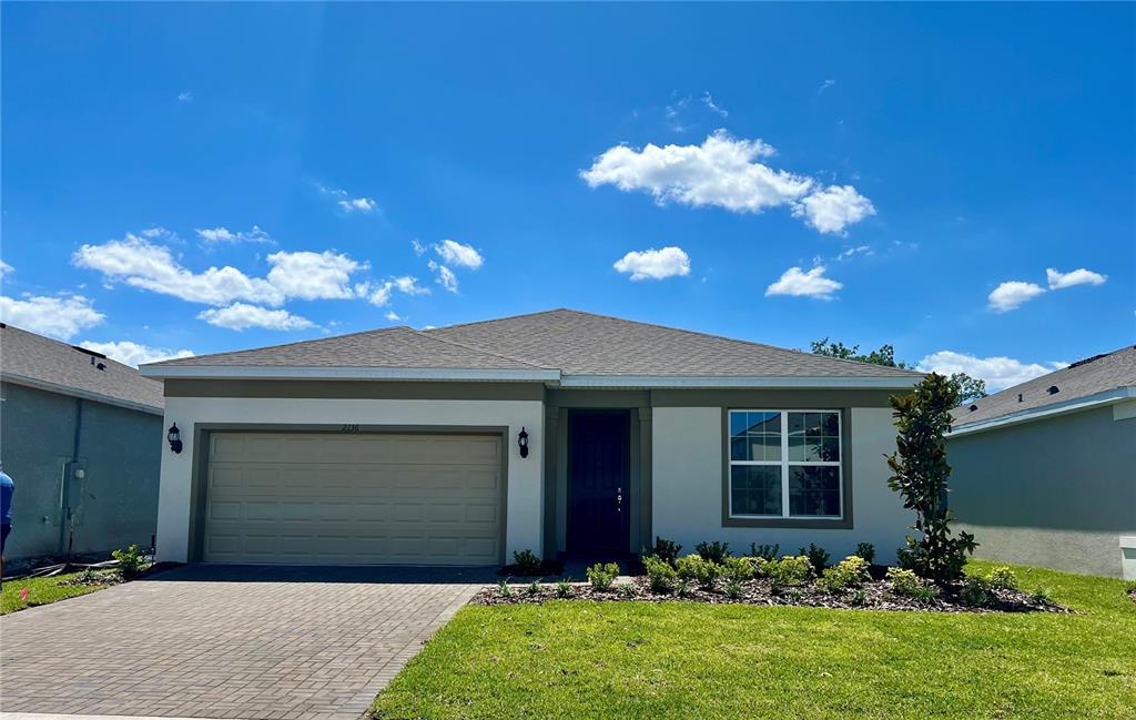 a front view of a house with a yard and garage