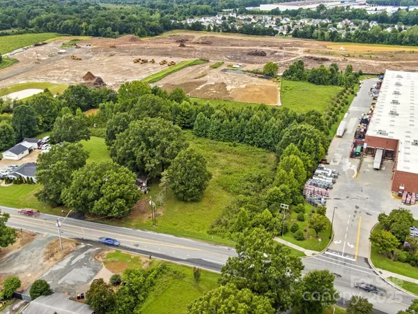 an aerial view of ocean with residential house and outdoor space