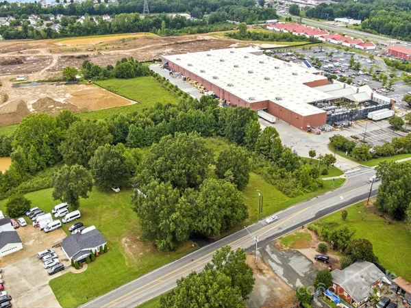 an aerial view of a residential houses with yard
