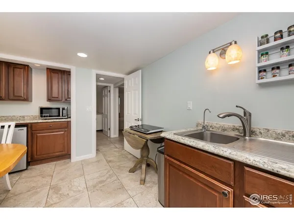 a kitchen with a sink appliances and cabinets