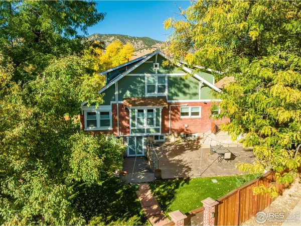 a view of a house with a tree in the yard