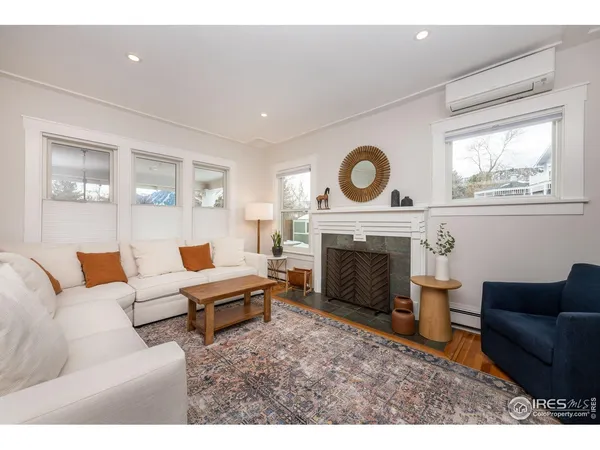 a living room with furniture and a fireplace