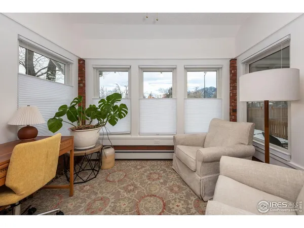 a living room with furniture flowerpot and wooden floor