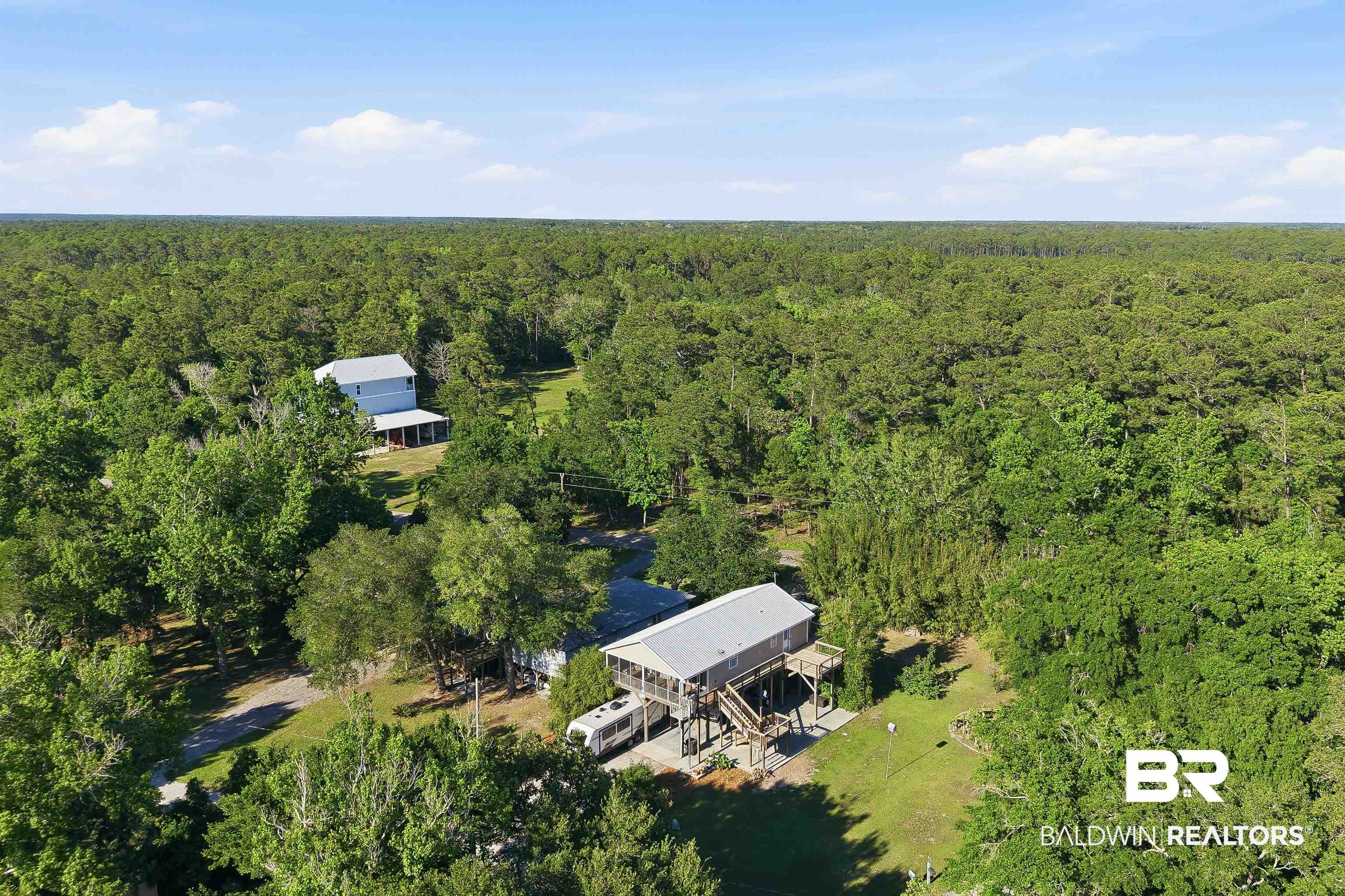 9624 North Bay Street Foley, AL 36535 - Photo 54 of 59 Elevated stilt home featuring a metal roof and a covered porch