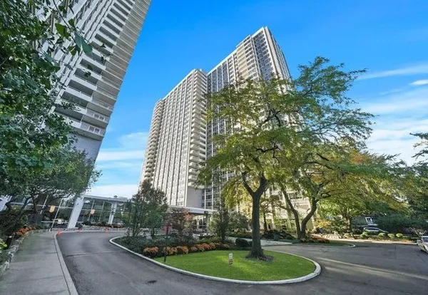 a view of a multi story building with a yard