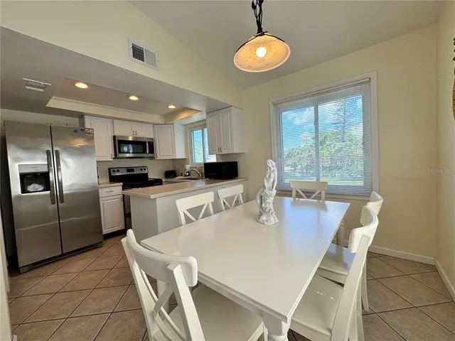 a kitchen with kitchen island a large counter top space appliances and cabinets