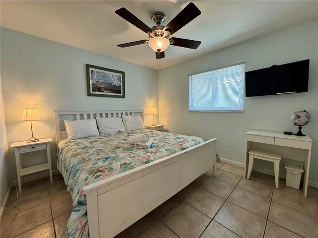 a bedroom with a bed and a flat screen tv