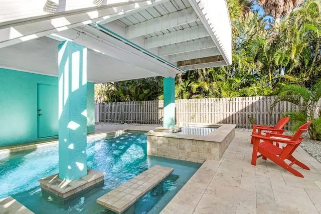 a bench sitting in backside of a house with wooden floor