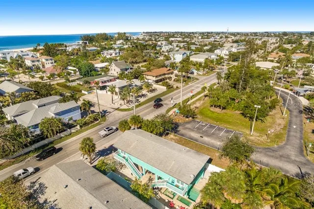 an aerial view of residential houses with outdoor space