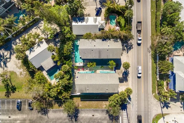 an aerial view of a house with a yard and fountain in front of it
