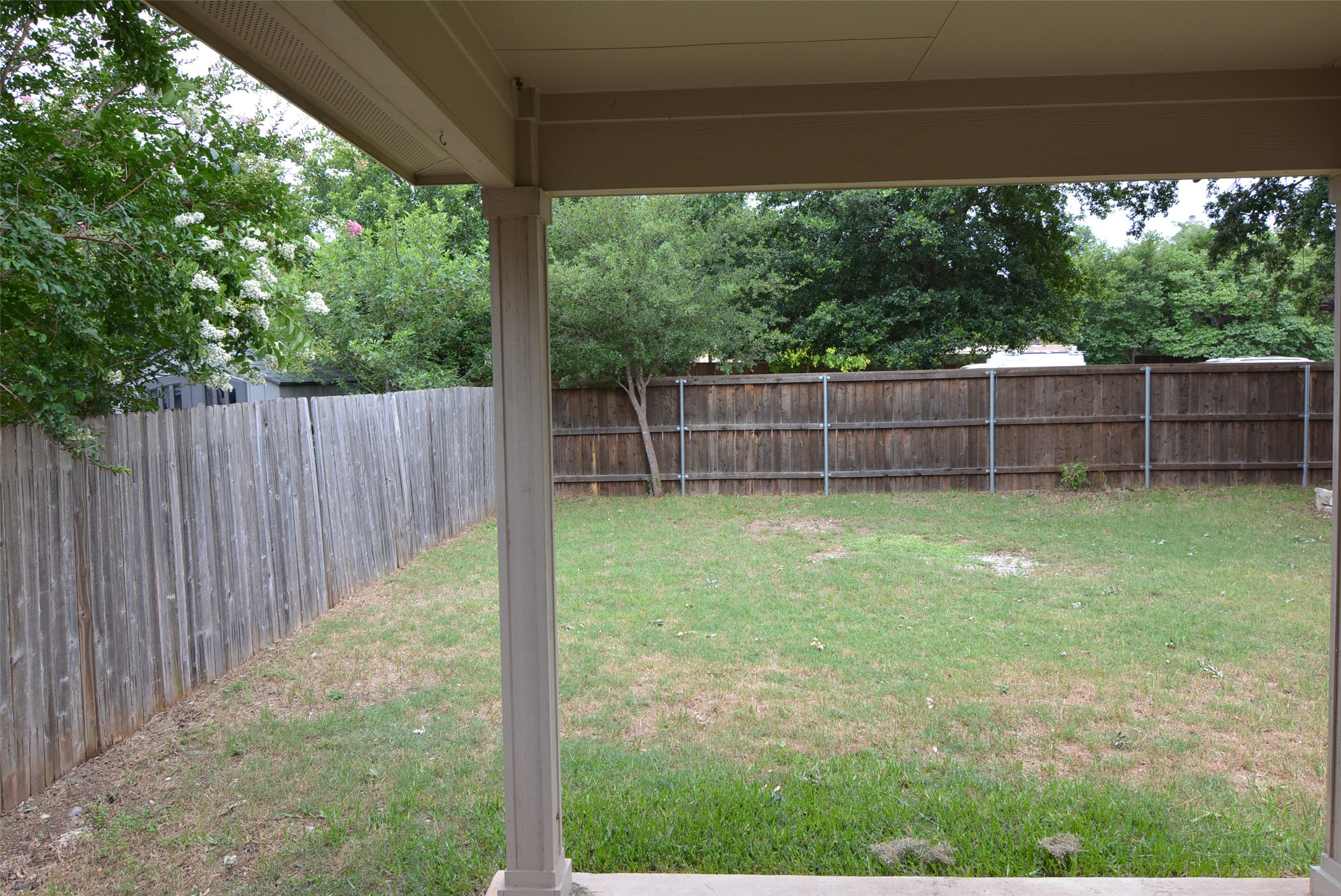 1303 Horseshoe Ranch Drive Leander, TX 78641 - Photo 24 of 26 A spacious backyard with mature trees offers privacy and room for recreation.