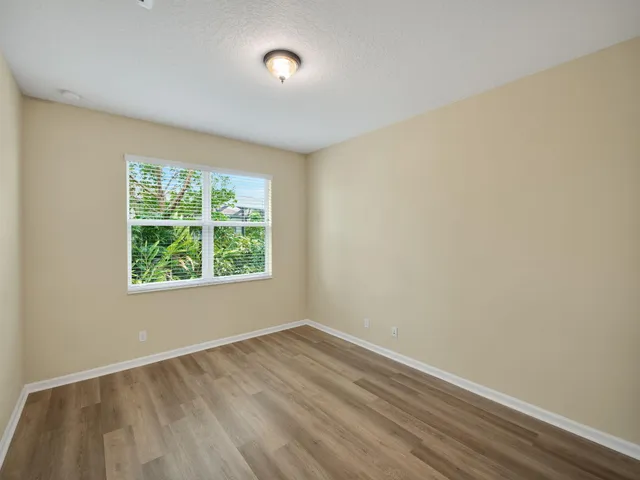 a front view of house with a garden
