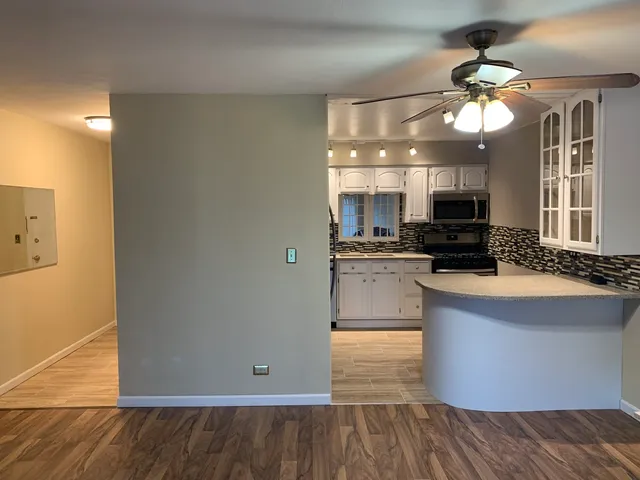 a kitchen with a refrigerator and a stove top oven