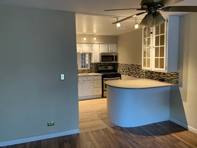 a kitchen with a refrigerator and a stove top oven