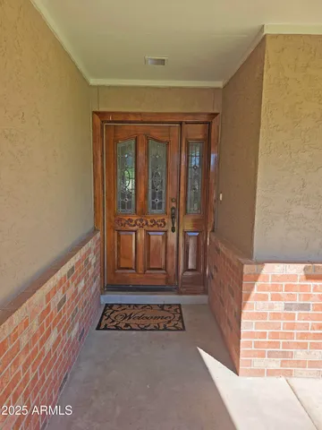 a kitchen with granite countertop a stove a sink and a refrigerator