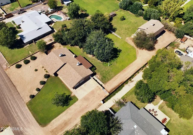 a front view of a house with a garden and trees