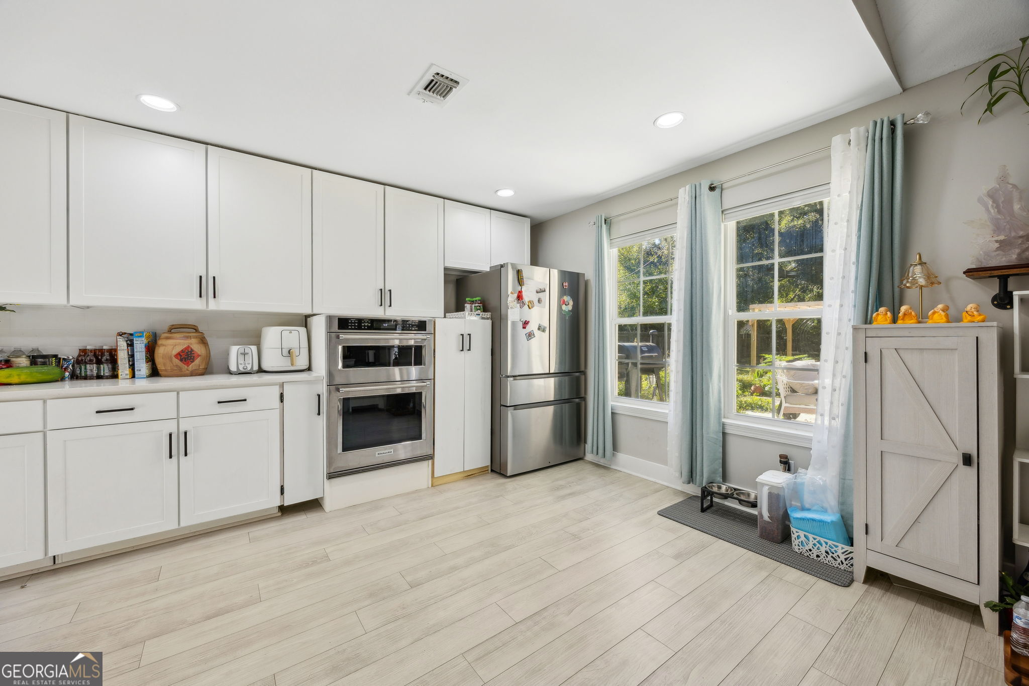 203 Foxwood Circle St. Marys, GA 31558 - Photo 11 of 52 a kitchen with stainless steel appliances a refrigerator and a stove top oven