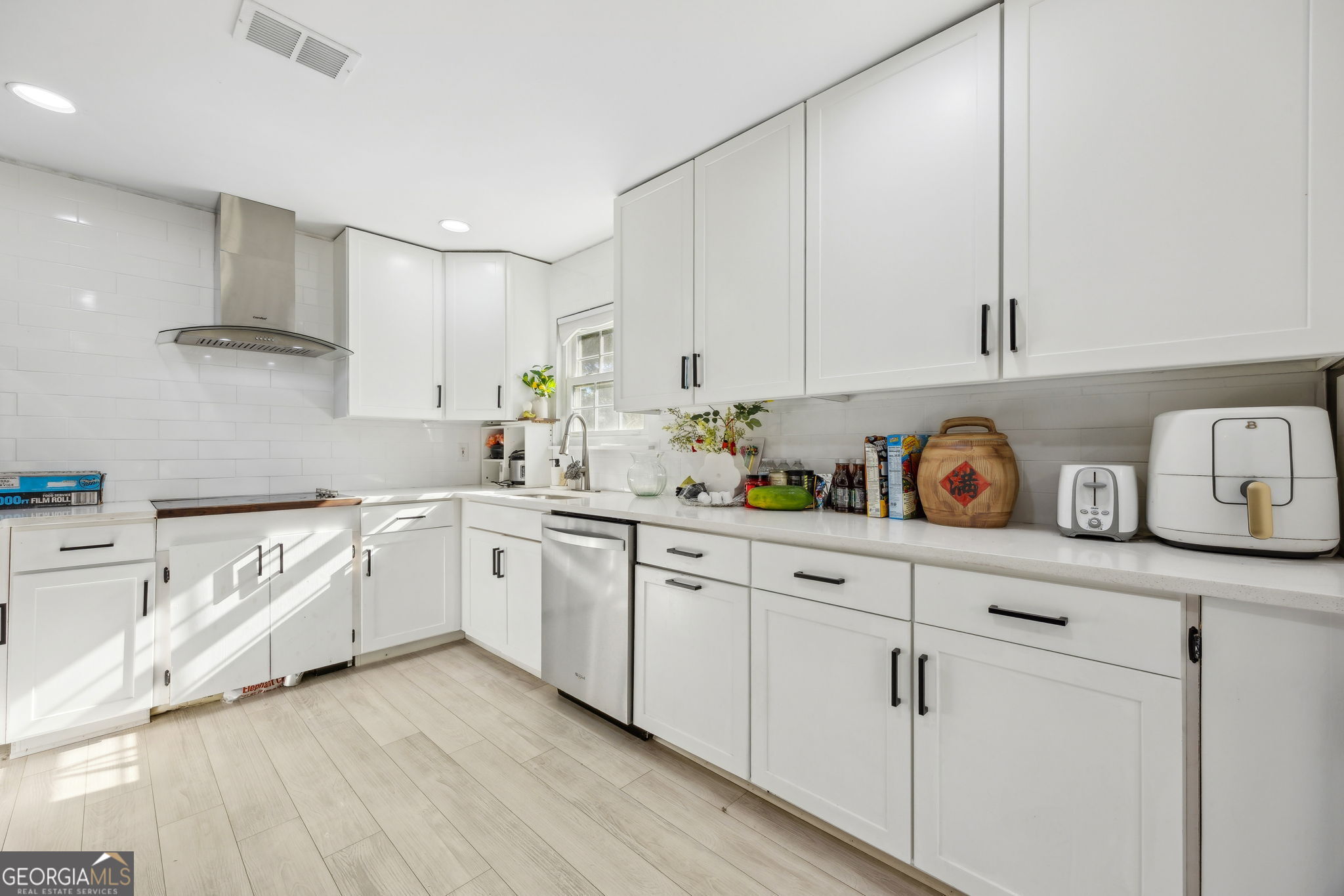 203 Foxwood Circle St. Marys, GA 31558 - Photo 13 of 52 a kitchen with granite countertop white cabinets and white appliances