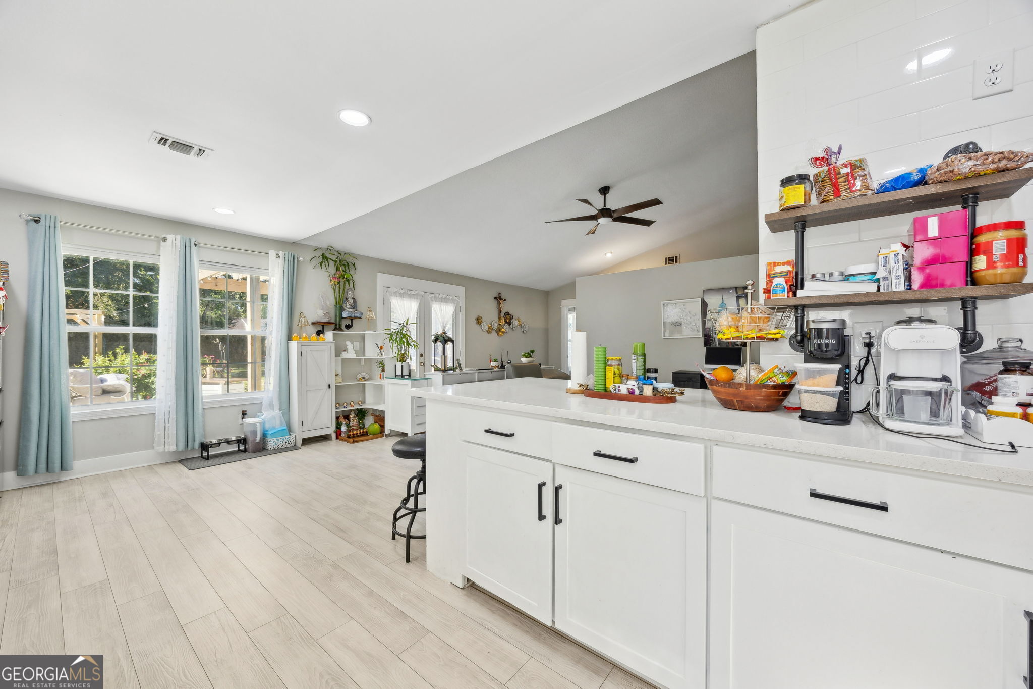 203 Foxwood Circle St. Marys, GA 31558 - Photo 15 of 52 a kitchen with sink cabinets and living room view
