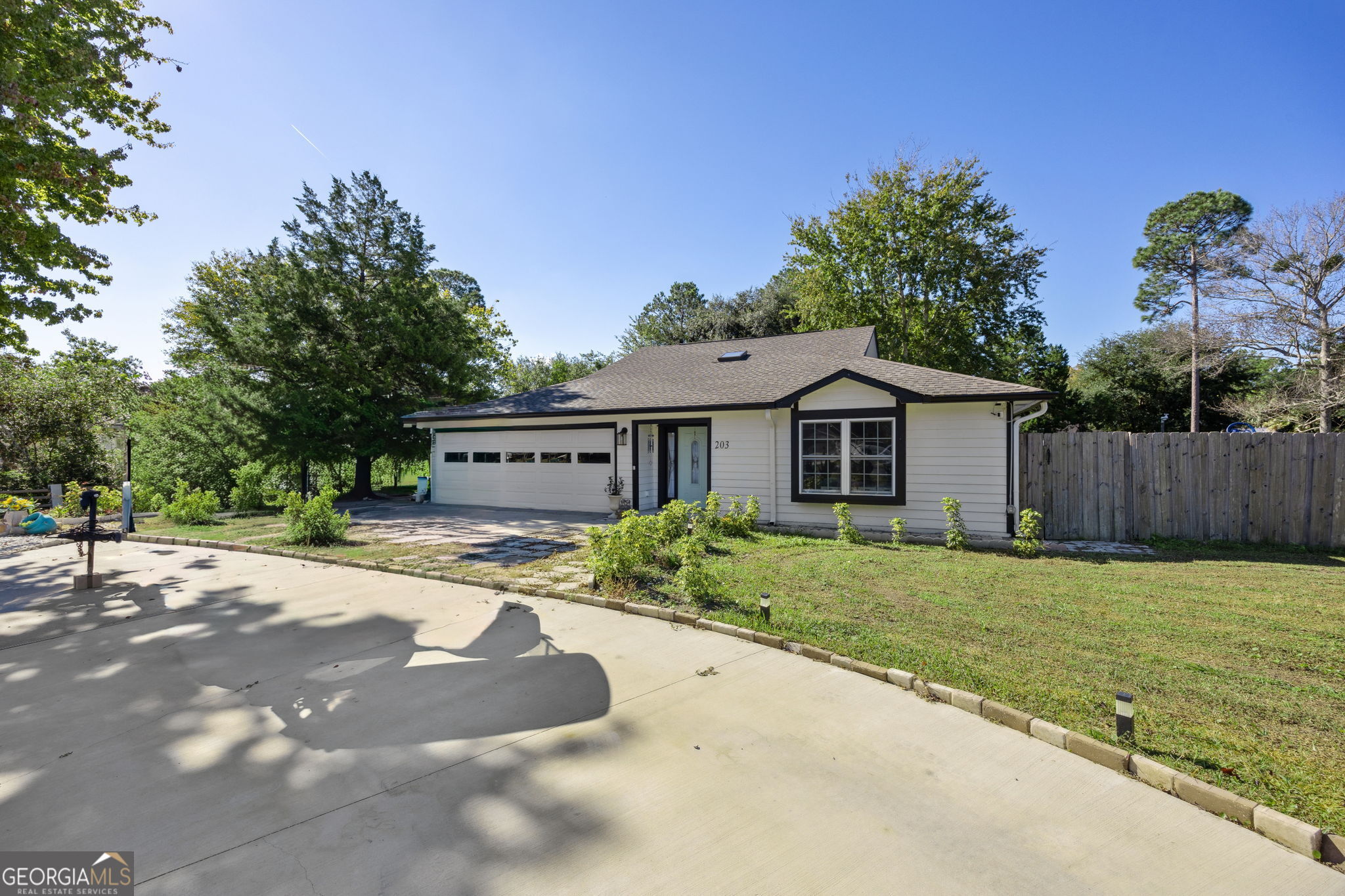 203 Foxwood Circle St. Marys, GA 31558 - Photo 2 of 52 a front view of a house with a garden and yard
