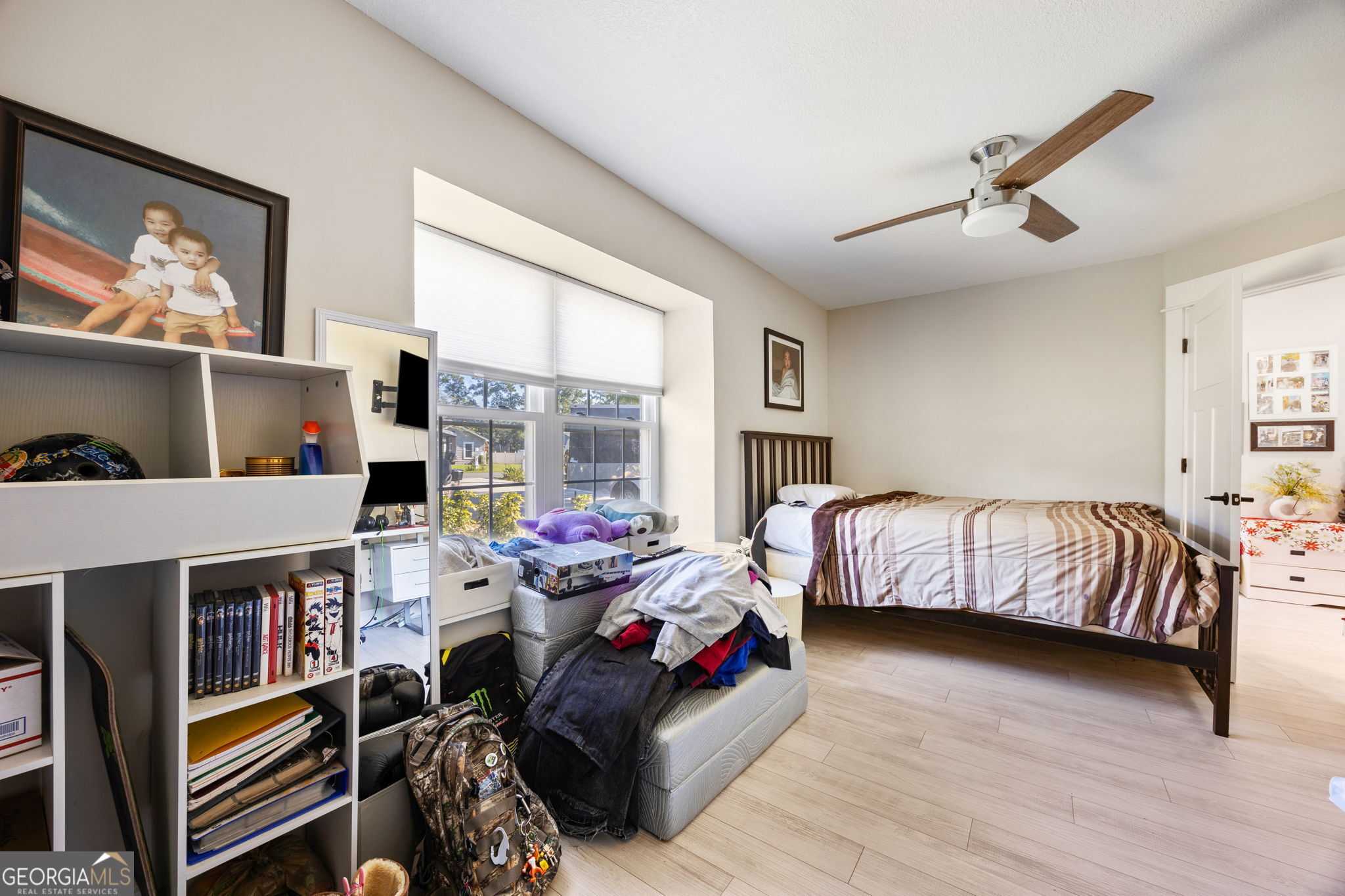 203 Foxwood Circle St. Marys, GA 31558 - Photo 25 of 52 a bedroom with bed and a large window
