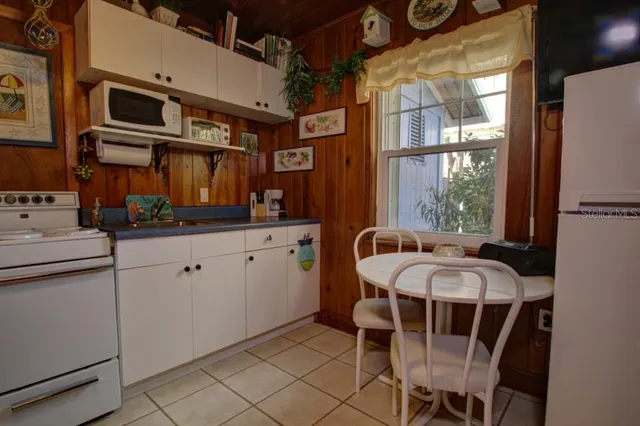 a bedroom with a bed and large windows
