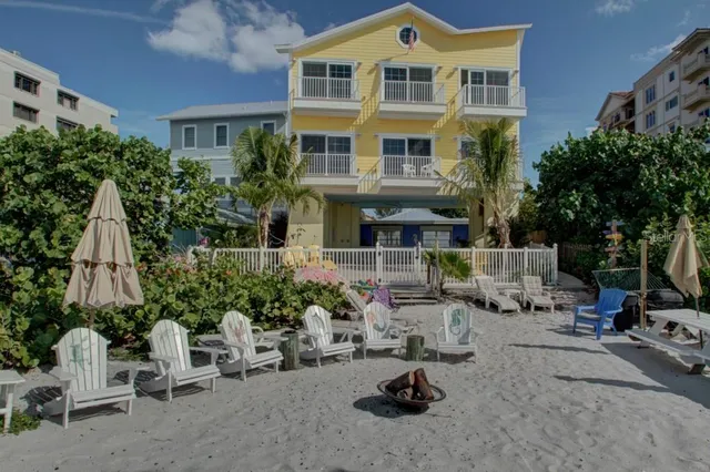 a view of a chair and tables in the patio of the house