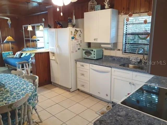 a kitchen with stainless steel appliances kitchen island granite countertop a refrigerator and a stove