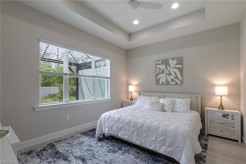 8909 Yucatan Court Naples, FL 34113 - Photo 8 of 36 Bedroom featuring a raised ceiling, a ceiling fan, and recessed lighting