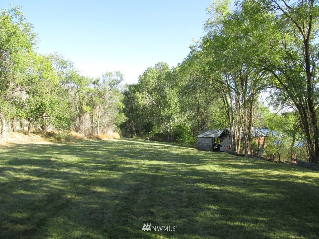 111 Frank Road Omak, WA 98841 - Photo 22 of 25 a view of a grassy field with trees