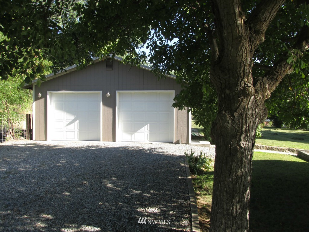 111 Frank Road Omak, WA 98841 - Photo 5 of 25 a front view of a house with a yard and garage