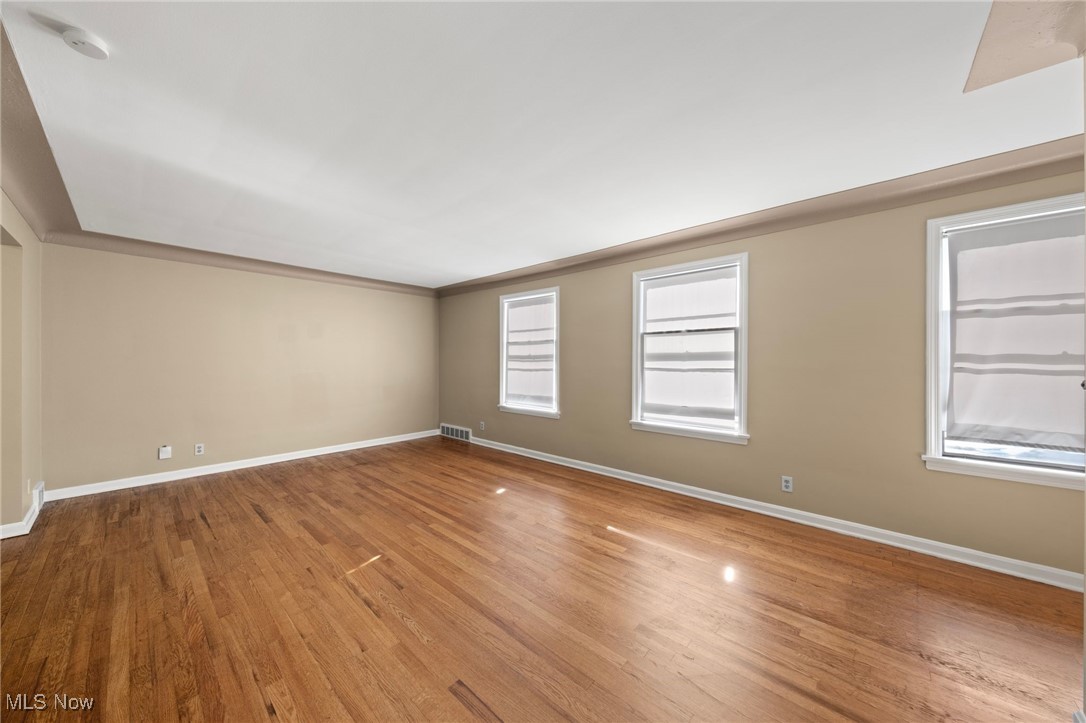 13517 Cedar Road Cleveland, OH 44118 - Photo 27 of 30 Empty room featuring hardwood / wood-style flooring and ornamental molding