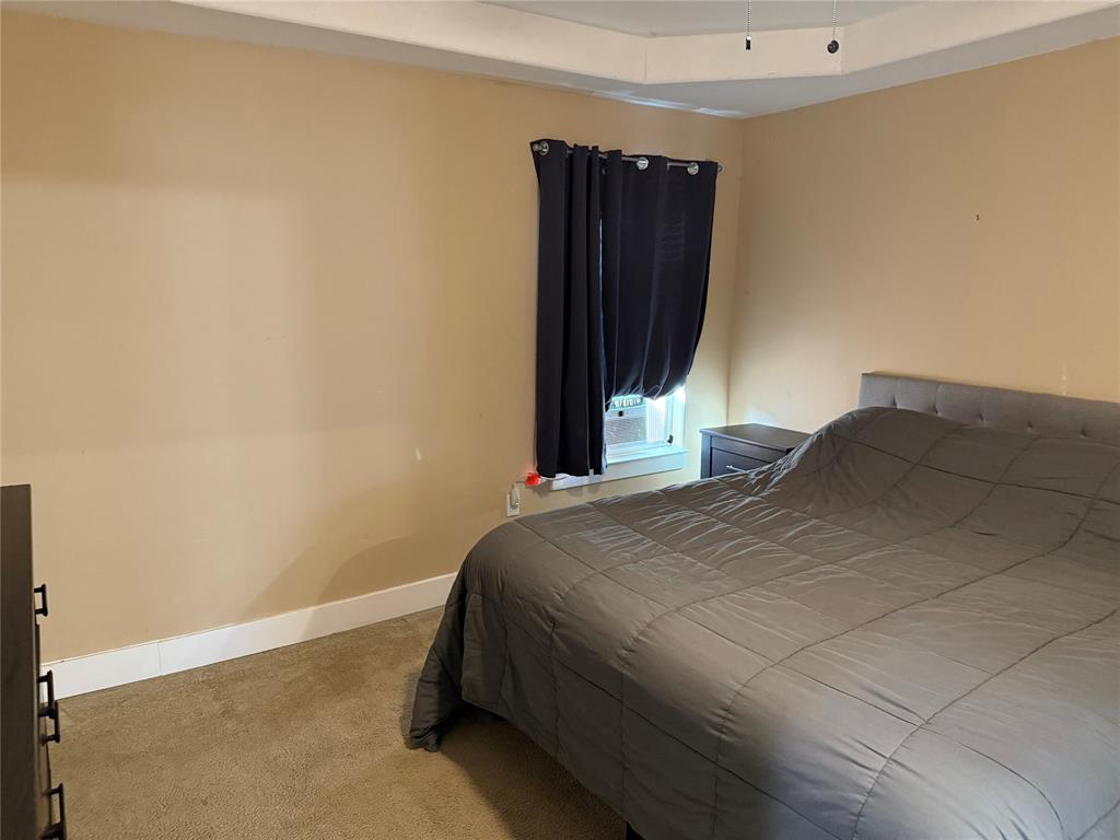 809 South Wine Street Gainesville, TX 76240 - Photo 15 of 33 a bedroom with a bed and a closet