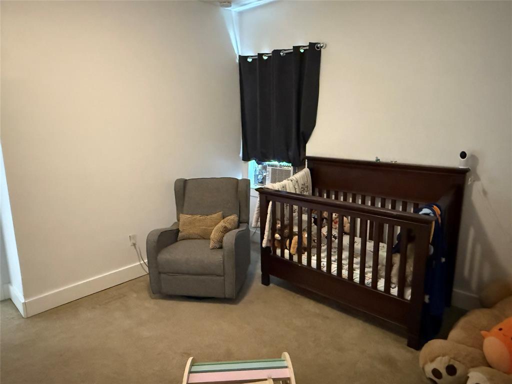 809 South Wine Street Gainesville, TX 76240 - Photo 20 of 33 Carpeted bedroom with a nursery area and a baseboard radiator
