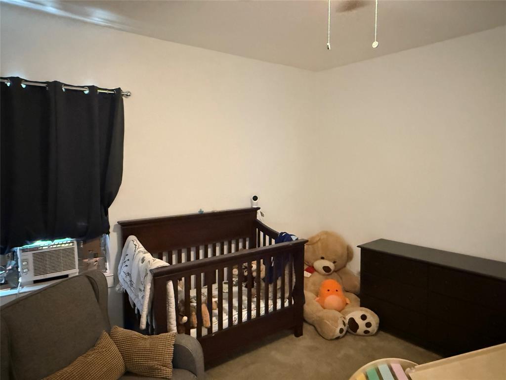 809 South Wine Street Gainesville, TX 76240 - Photo 21 of 33 a bedroom with furniture and a baby crib