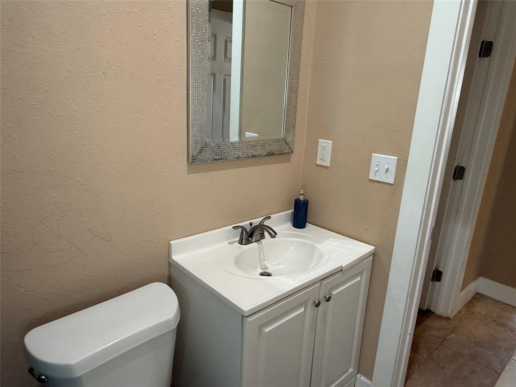 809 South Wine Street Gainesville, TX 76240 - Photo 22 of 33 a bathroom with a sink and a toilet